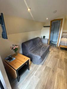 a living room with a couch and a table at Morvan Pod in Fort William