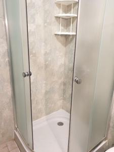 a shower with a glass door in a bathroom at Cozy apartment by Julie in Sunny Beach