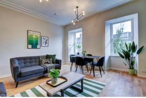 uma sala de estar com um sofá e uma mesa em Coorie Doon - Aparthotel - Troon em Troon