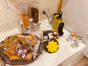 a counter top with a basket of food and a blender at Dimora Giuditta in Brindisi