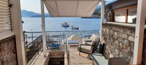 a balcony with a view of the water and a boat at Lux Beach House M in Pržno