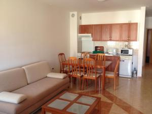 a living room with a couch and a table and a kitchen at Apartment Volme in Pula