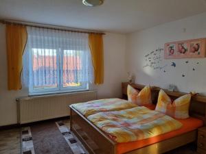 a bedroom with a bed and a window at Ferienhaus in Thüringen Nähe Hohenwarte Stausee in Unterwellenborn