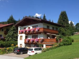 a building with flowers on the balconies of it at Haus Ganschitter in Wagrain