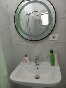 a bathroom with a sink and a mirror at Green Forest in Berat