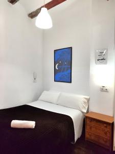 a bedroom with a large bed with a black blanket at Sampedor Apartment in Valencia