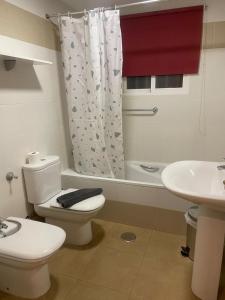 a bathroom with a white toilet and a sink at FH CAMP PRECIÓS I in Altea