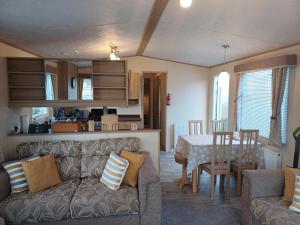 a living room and kitchen with a couch and a table at The Highlander in Tain