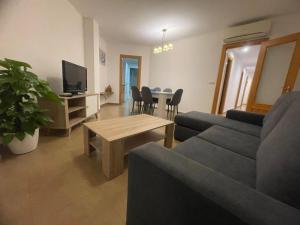 a living room with a couch and a table at FH CAMP PRECIÓS I in Altea