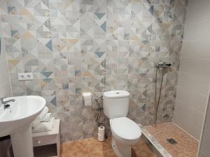 a bathroom with a toilet and a sink at Llar de Laura in El Poblenou del Delta +27 photos
