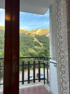 a door to a balcony with a view of a mountain at Giappetto House in Limone Piemonte