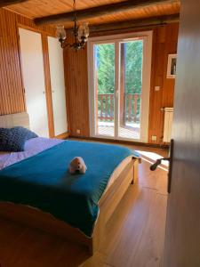 a bedroom with a bed with a stuffed animal on it at L'ânon d'Andon in Andon