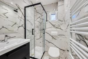 a bathroom with a shower and a toilet and a sink at PARIS CITY-Le Raincy - Facing station - 4 to 8 Pers in Le Raincy +91 photos