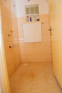 a small bathroom with a shower and a window at Deci Homes in Ruaka
