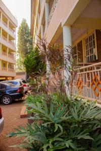 a building with a bunch of plants in front of it at Deci Homes in Ruaka