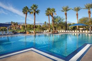 uma grande piscina com palmeiras num resort em Marriott's Shadow Ridge II - The Enclaves em Palm Desert