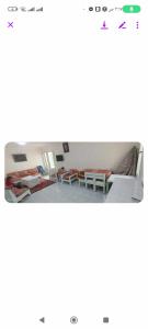 a room with beds and tables in it at فيلا دوبلكس على البحر مباشره in Arish