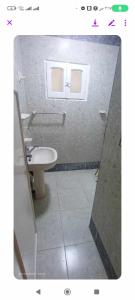 a bathroom with a white sink and a toilet at فيلا دوبلكس على البحر مباشره in Arish