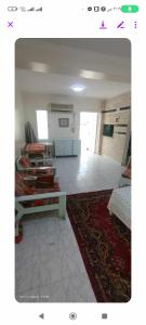 a living room with several beds and a rug at فيلا دوبلكس على البحر مباشره in Arish