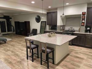 a kitchen with a large island in the middle at Beautiful 3bedroom & loft home with mountains view in Denver