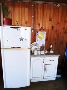 cocina con nevera blanca y encimera en Cabaña Payun, en Lonquimay