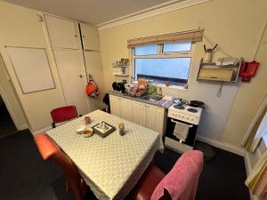 a small kitchen with a table and a stove at Central Lisburn Accommodation in Lisburn
