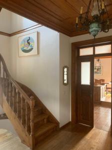 a staircase in a house with a wooden ceiling at House in Propan in Kalamaki