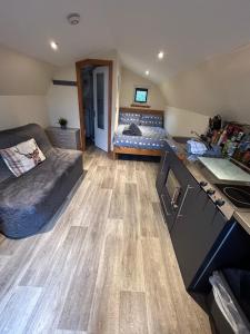 a room with a kitchen and a living room at Morvan Pod in Fort William