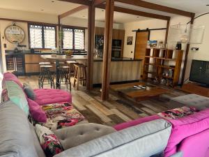 a living room with two couches and a kitchen at Villa Edna in Sainte-Rose