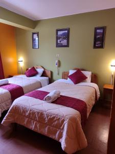 um quarto de hotel com duas camas e duas lâmpadas em Krusty Hostel B&B em Huaraz