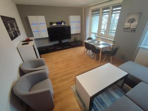 a living room with a couch and a table at Apartament Mickiewicza w centrum Augustowa in Augustów