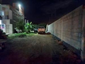 a car parked next to a wall at night at Monoambientes Chamical in Chamical