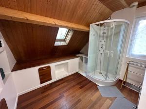 a large bathroom with a shower in a attic at La Maison Verte in Clécy +49 photos