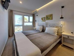 A bed or beds in a room at Sand and Sea