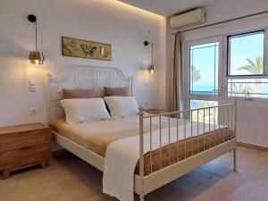 A bed or beds in a room at Sand and Sea