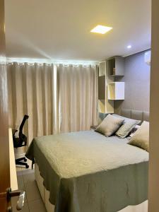 a bedroom with a bed and a window at APART HOTEL MANAÍRA PALACE in João Pessoa