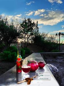 a table with a glass of wine and some apples at Casa Horizon in Porto Heli