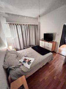 a bedroom with a bed and a television in it at CASA EN LA FELIZ - pet friendly in Mar del Plata