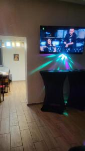 a flat screen tv on a wall with a table at Apartamenty Premium PRETTY WOMAN self check-in 24h - Bytom Chorzów Katowice in Bytom