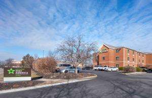 a building with a sign in front of a parking lot at Extended Stay America Select Suites - Cincinnati - Florence - Meijer Dr in Florence
