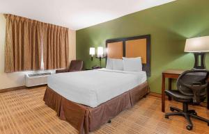 a hotel room with a large bed and a desk at Extended Stay America Suites - Cincinnati - Florence - Turfway Rd in Florence