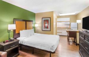 a hotel room with a bed and a kitchen at Extended Stay America Suites - Salt Lake City - Sugar House in Salt Lake City