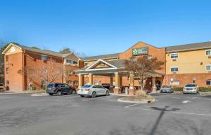 a parking lot in front of a hotel with cars parked at Extended Stay America Suites - Chesapeake - Churchland Blvd in Chesapeake