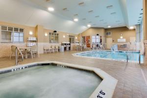 a swimming pool in a room with a kitchen and a dining room at Drury Inn & Suites St. Louis/O'Fallon, IL in O'Fallon