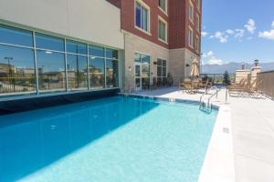 a swimming pool in front of a building at Drury Inn & Suites Colorado Springs Near the Air Force Academy in Colorado Springs