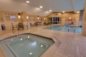 a pool in a hotel room with a swimming pool at Drury Inn & Suites Baton Rouge in Baton Rouge