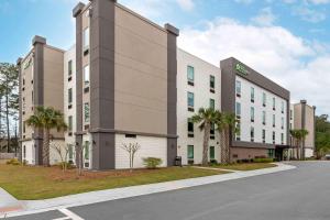 a large office building with palm trees in front of a street at Extended Stay America Premier Suites - Bluffton - Hilton Head in Bluffton