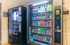 a refrigerator filled with lots of sodas and drinks at Extended Stay America Select Suites - Kansas City - Stadium in Independence