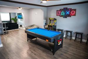 a room with a pool table in a living room at 5 min HardRock! Spacious Serenity 4BR Dream Home in Miami
