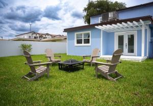 a group of chairs and a table in front of a house at 5 min HardRock! Spacious Serenity 4BR Dream Home in Miami